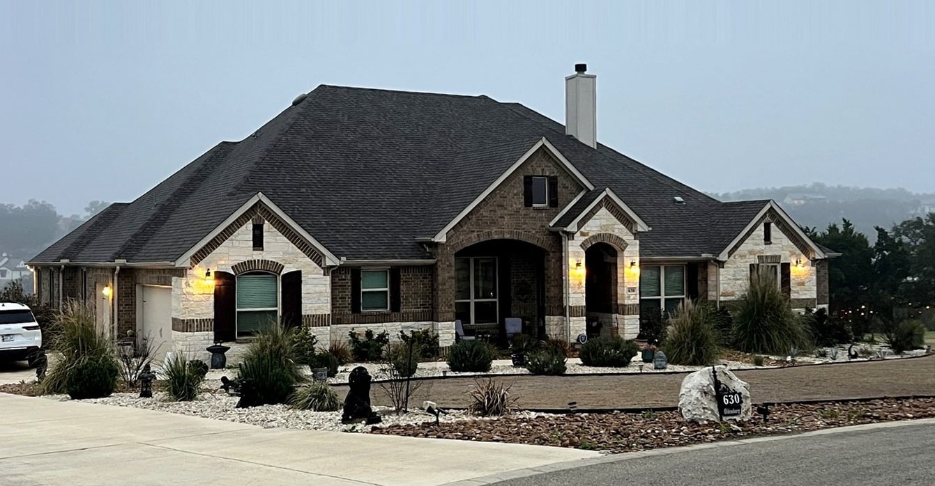 Texas home during the day with permanent lighting installed but invisible from the curb.