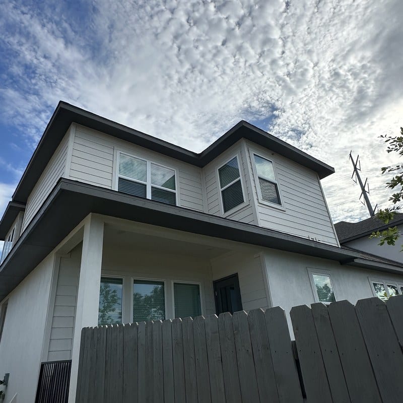 Dazzl consultant assessing a Texas home exterior during a free in-home quote appointment.