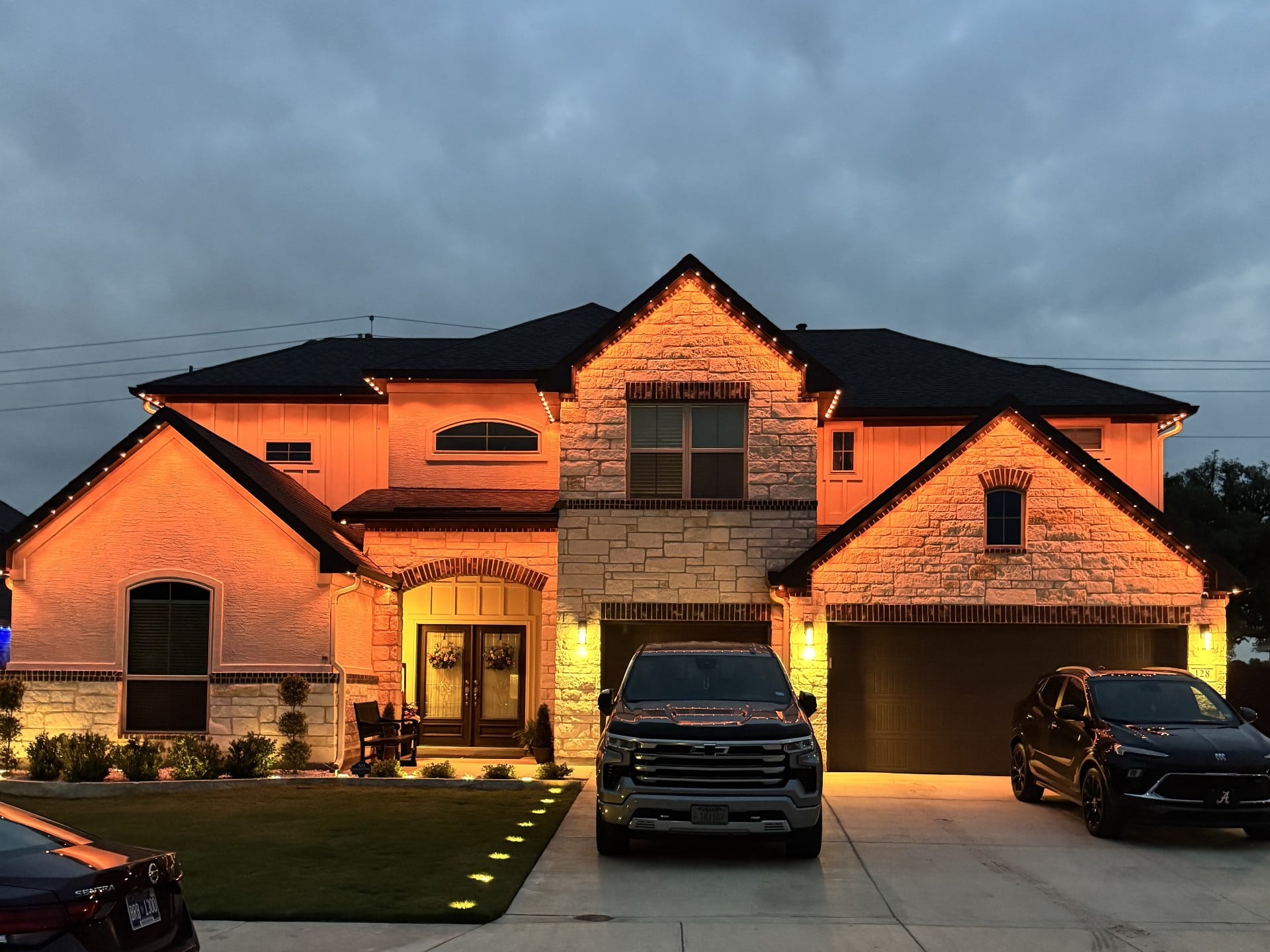 Same Texas home washed in burnt orange game-day permanent LED lighting
