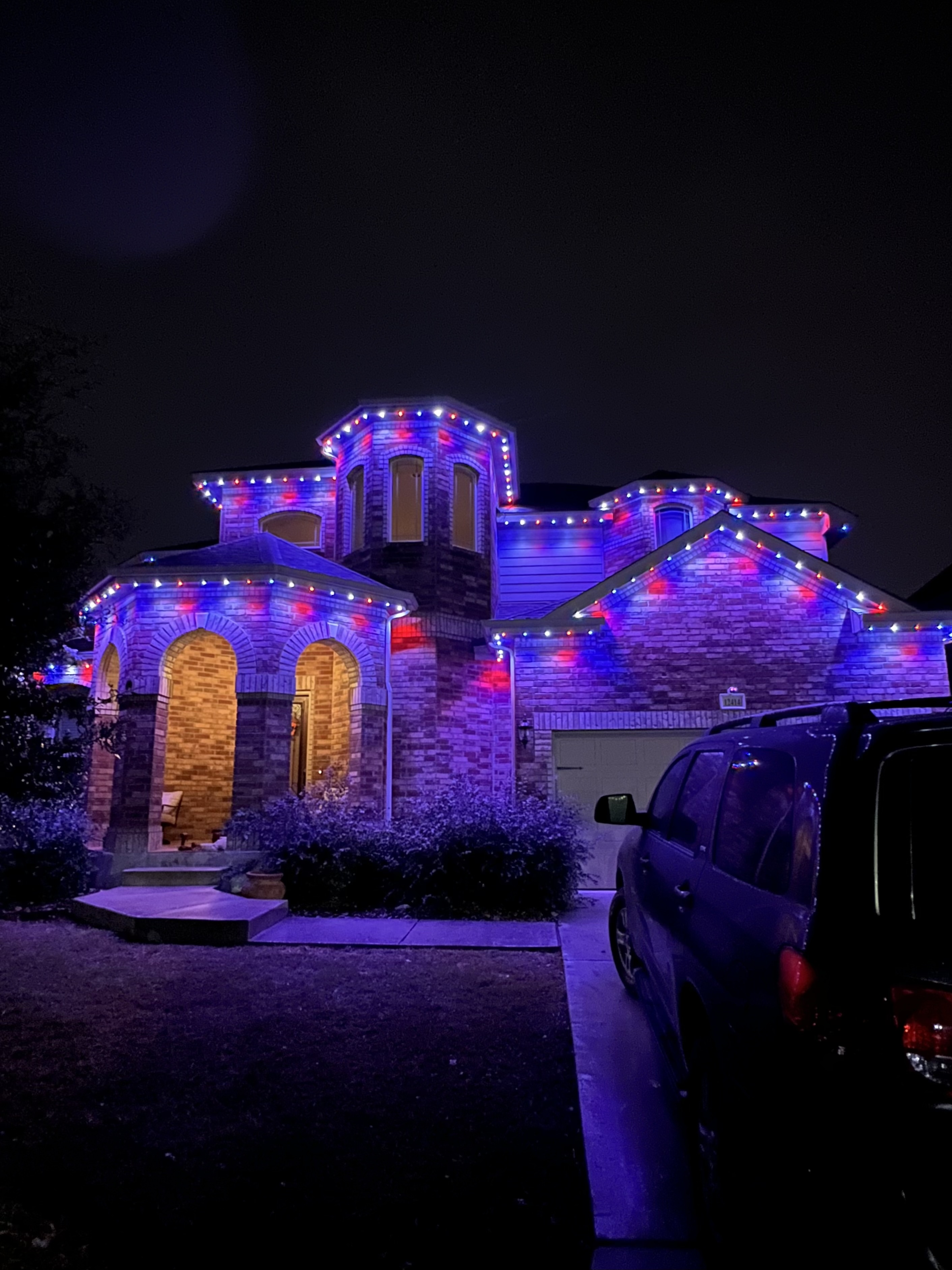 Texas brick home with red and blue patriotic permanent LED lighting